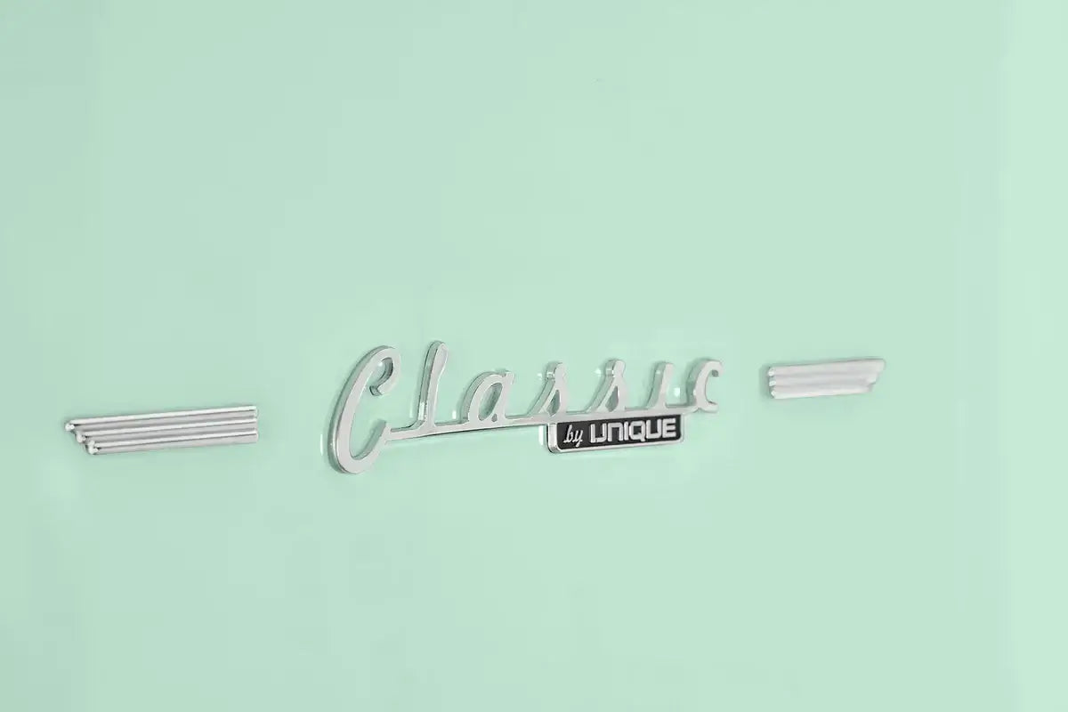 Classic Retro by Unique refrigerator chrome logo on mint green background at Cabin Depot.