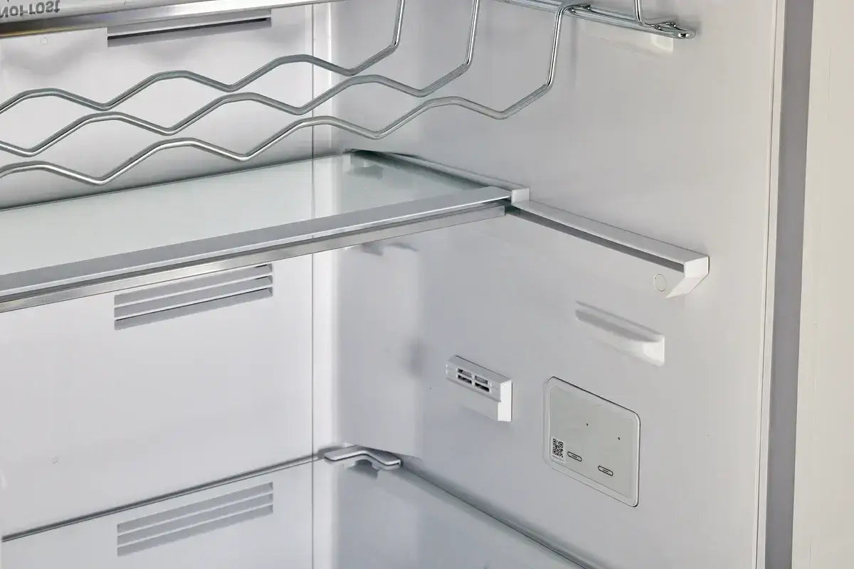 Interior view of Unique 12 Cu/Ft Retro Refrigerator with frost-free design, showcasing shelves and chrome accents. Available at Cabin Depot.