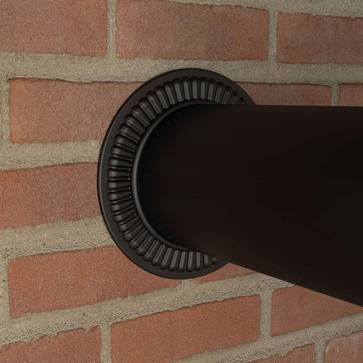 Black matte Imperial 6" trim collar made of 24-gauge steel installed on a brick wall.