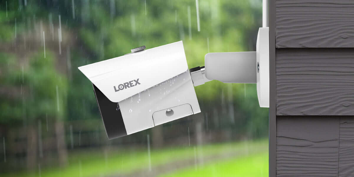 Lorex 4K IP Wired Bullet Camera mounted outside in rain, provided by Cabin Depot, offering ultra-clear video and night vision for security.