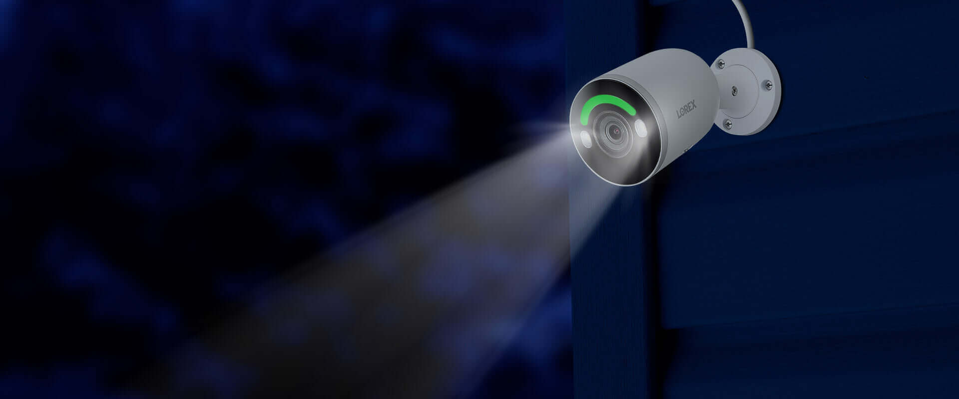 Lorex 4K Fusion IP Bullet Camera from Cabin Depot, night vision active, mounted on a building, part of a 16-channel NVR system.