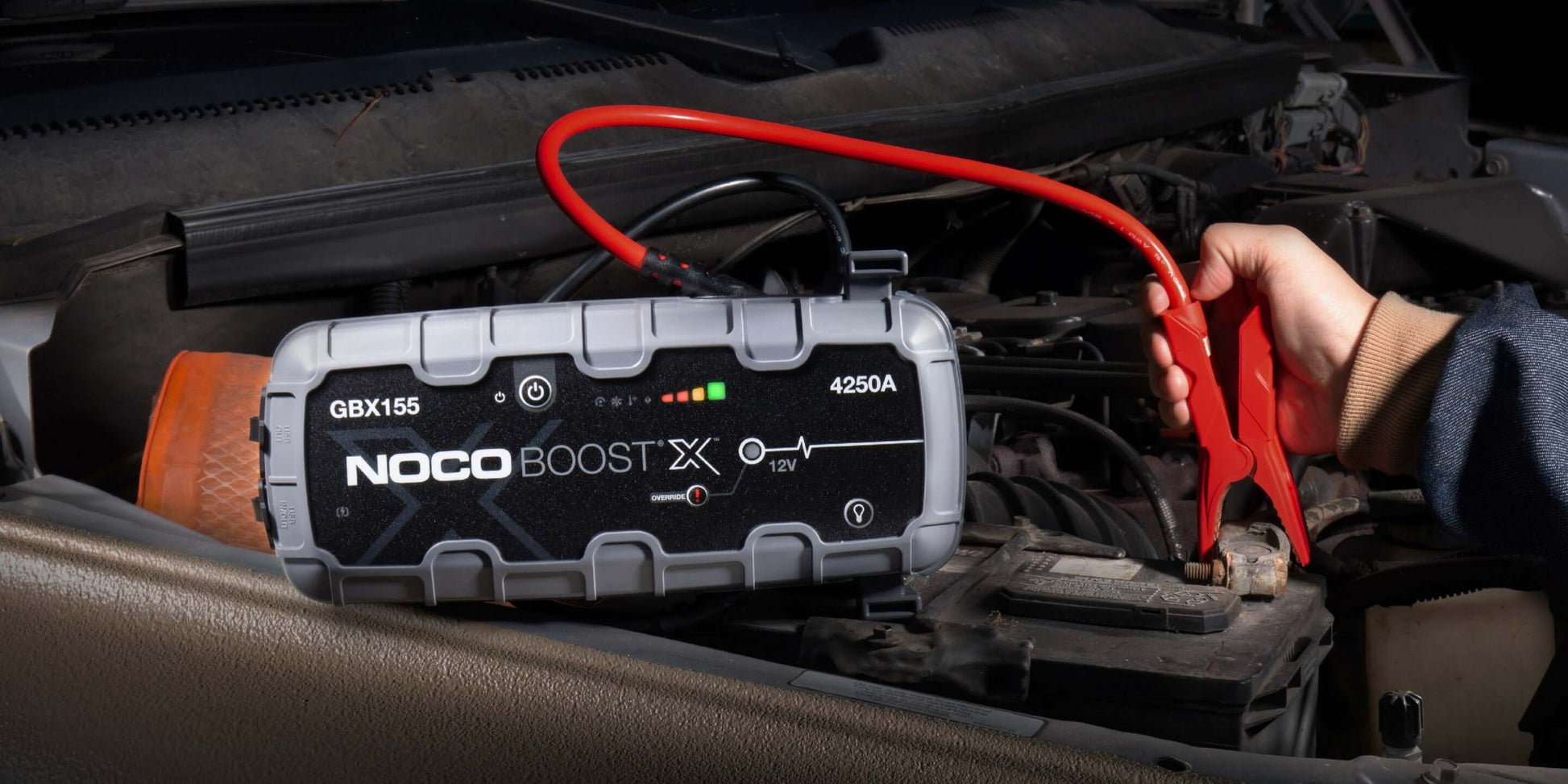 NOCO 12V 4250A Boost X Jump Starter in use, showcasing powerful engine starting capability for vehicles, available at Cabin Depot.