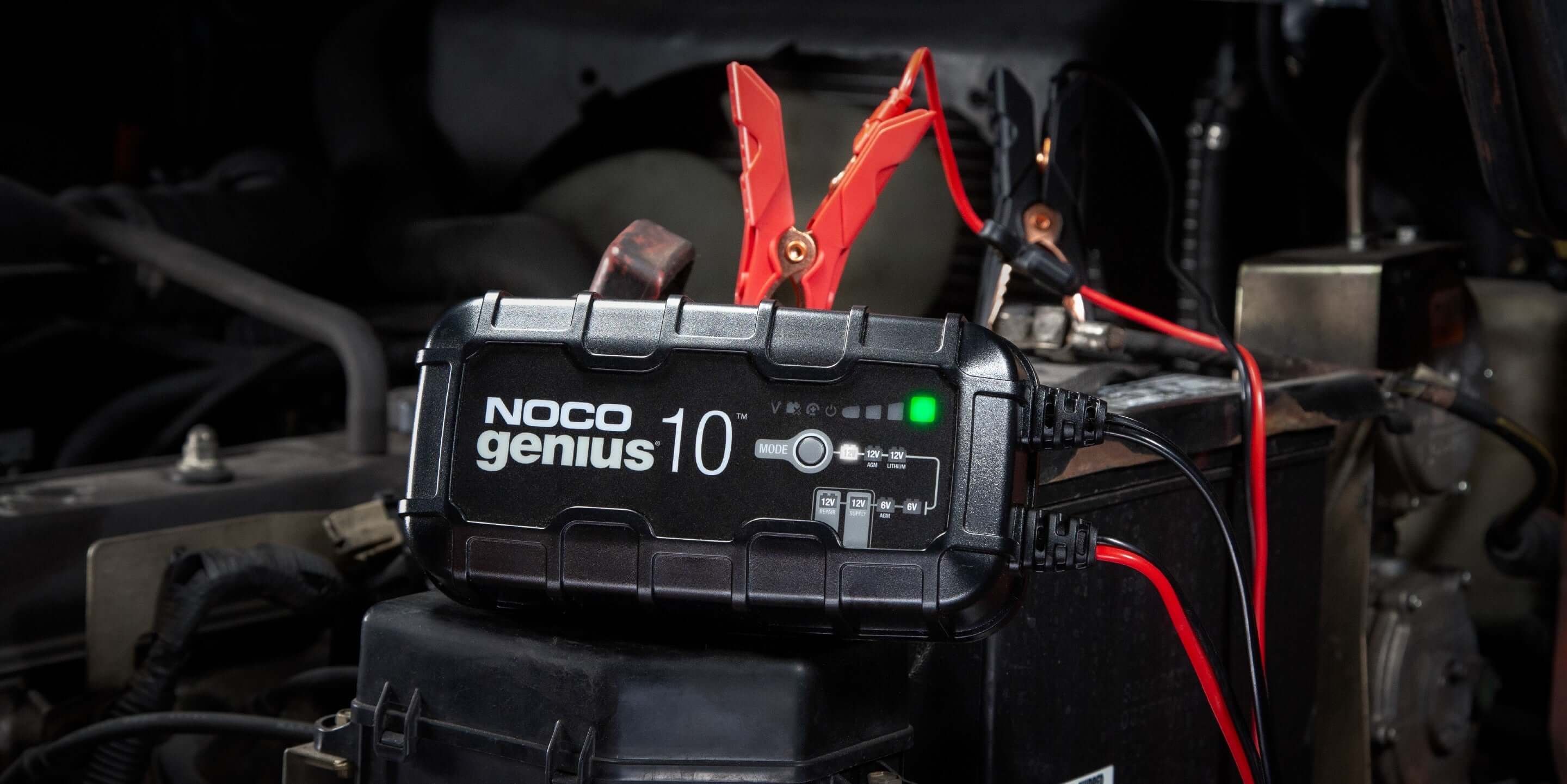 NOCO GENIUS10 10A Battery Charger in use, Cabin Depot, energy-efficient 6V-12V maintainer on automotive battery.