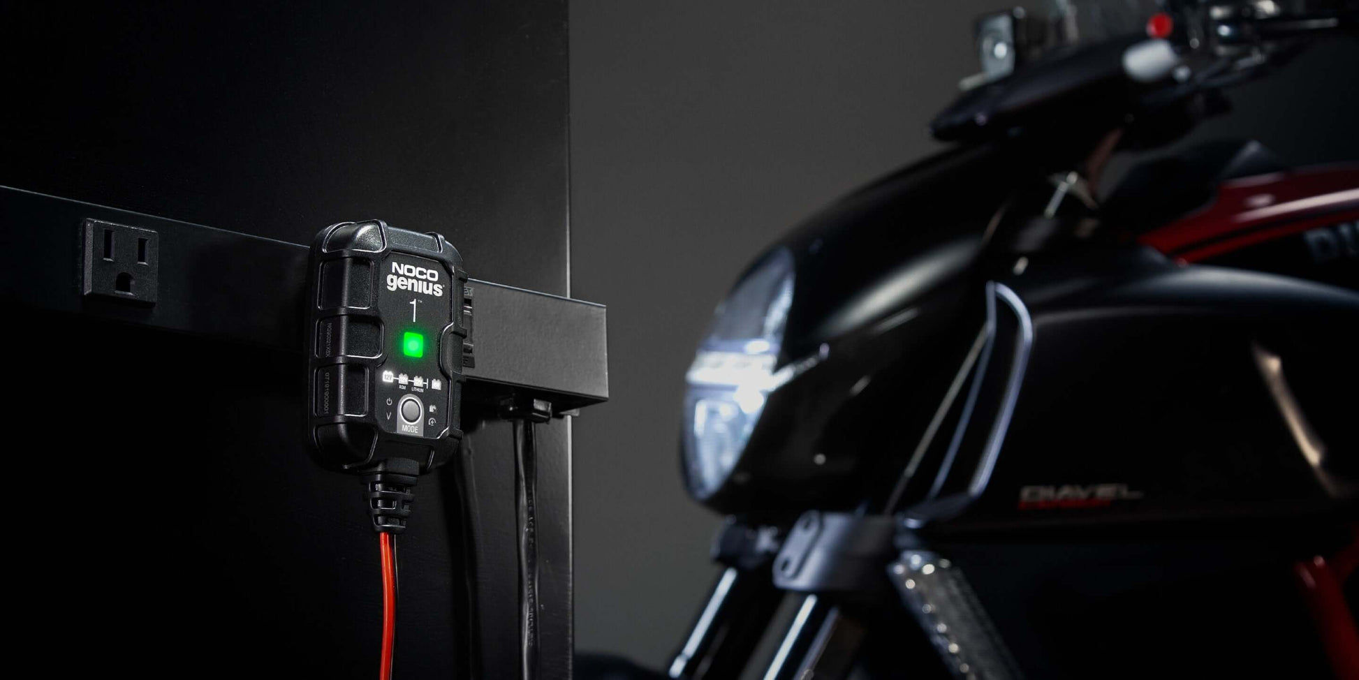 NOCO Genius1 1A Battery Charger connected to a motorcycle, showcasing energy efficiency for Cabin Depot customers.