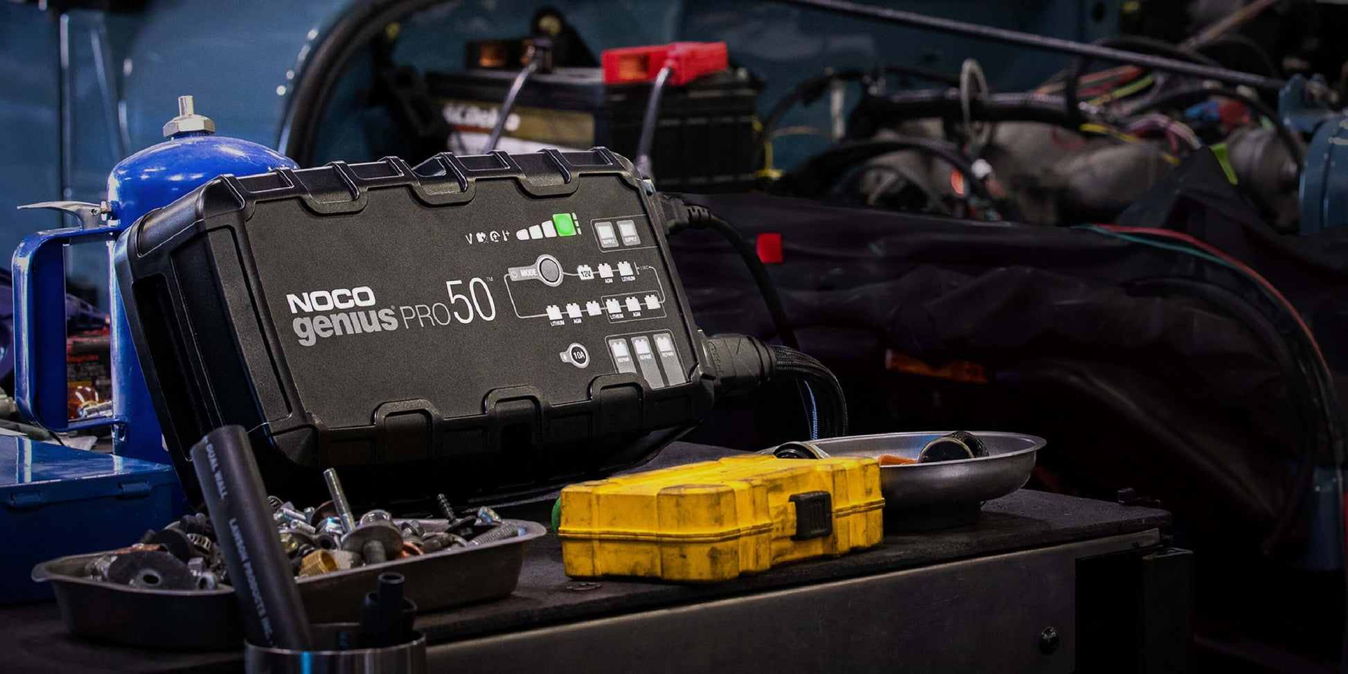NOCO 50A Pro Battery Charger GENIUSPRO50 in garage, ideal for automotive and marine use, available at Cabin Depot.