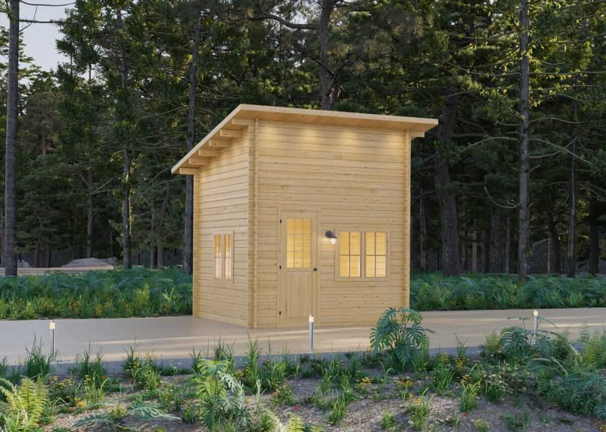 Compact wooden Cube Loft 100 cabin with adjustable slant roof by Cabin Depot, set in a lush forest setting at dusk.