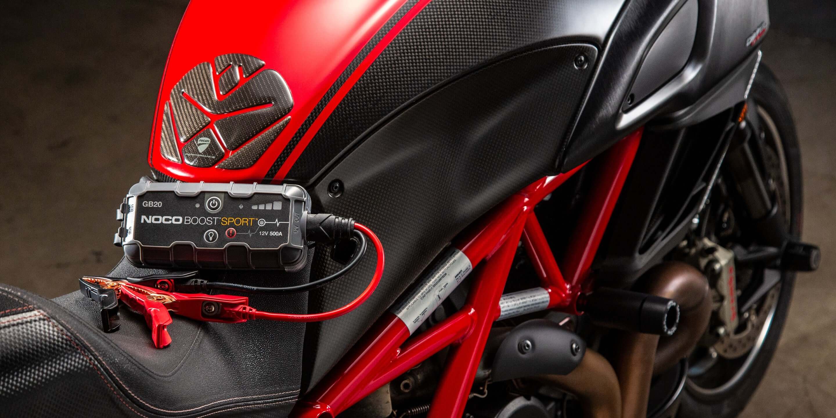 NOCO 12V 500A Boost Jump Starter in action on motorcycle, Cabin Depot portable power source, safe lithium-ion technology