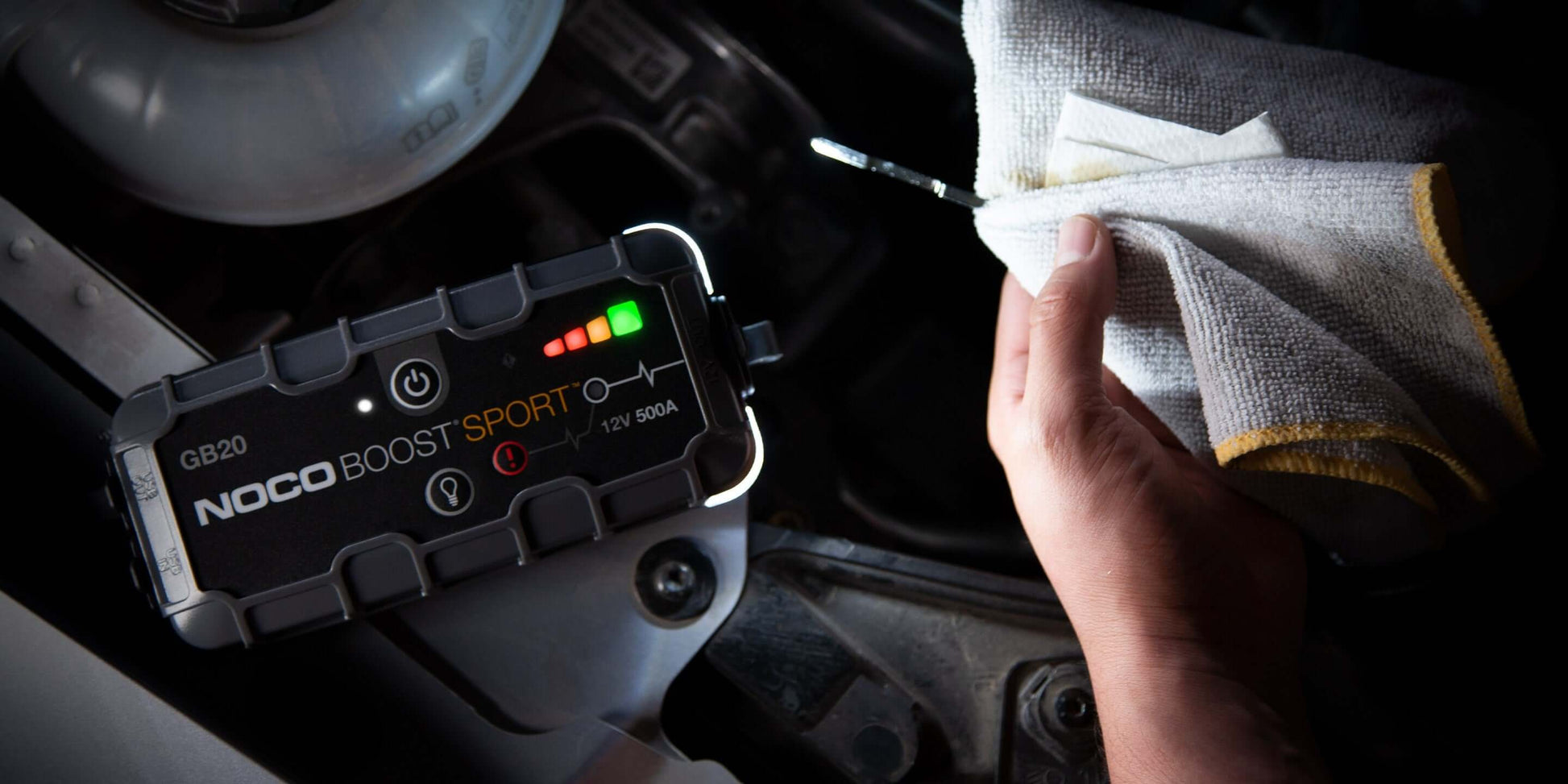 NOCO 12V 500A Lithium Jump Starter in action, designed with UltraSafe technology for engine boosts. Available at Cabin Depot.