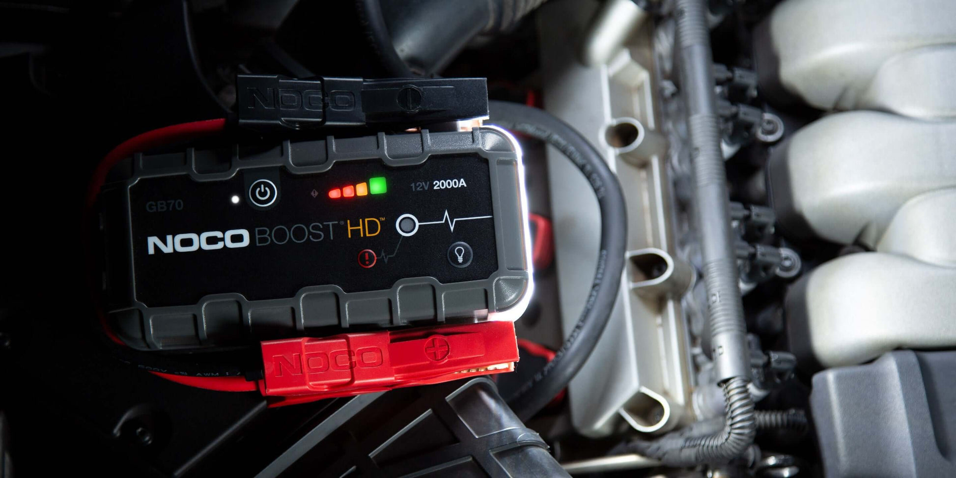 NOCO 12V 2,000A Boost Jump Starter GB70 in car engine bay, featuring UltraSafe Lithium technology for Cabin Depot.