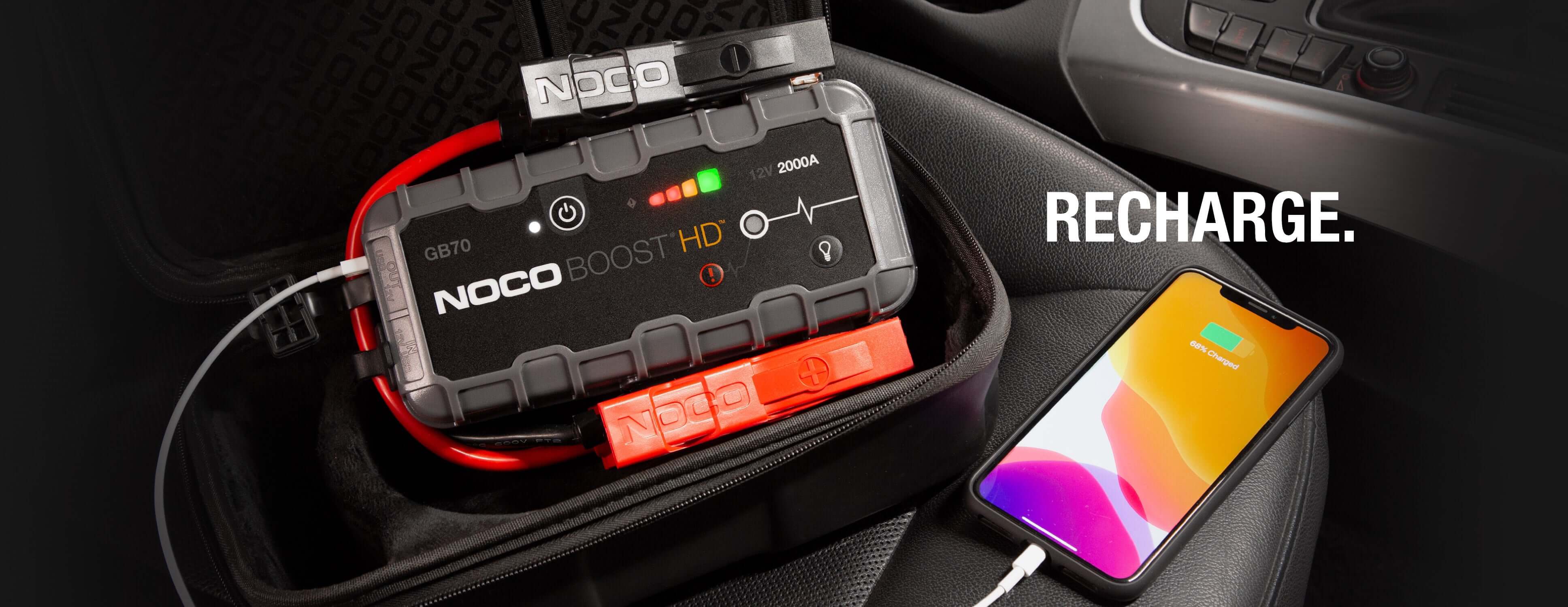 NOCO 12V 2,000A Boost Jump Starter recharging phone, ideal for Cabin Depot customers seeking a portable power solution.