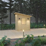 Loo Loo House Log Outhouse on wooden deck, versatile structure by Cabin Depot, ideal as bus shelter, ice hut, or tiny shed.