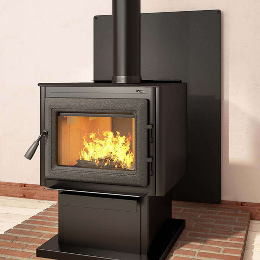 Modern wood stove with fire burning on a black pebble stove board for floor protection, featuring a sleek steel design.