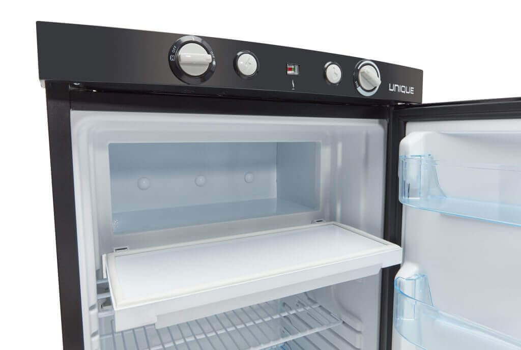 Interior view of Unique 3 cu/ft UGP-3 propane fridge with freezer, top-mounted controls, and versatile operation. Perfect for cabins. Cabin Depot.