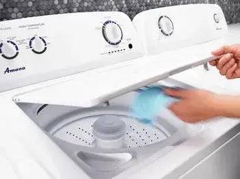 Person using Amana 4.4 Cu/Ft Top Load Washer in white with Dual Action Agitator, available at Cabin Depot.