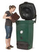 Woman using Biolan 220 ECO Composter for efficient kitchen and toilet waste composting.