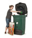 Woman using Biolan Biowaste 220 Eco Composter for efficient year-round composting of kitchen and toilet waste.