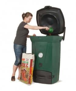 Woman using Biolan Biowaste 220 Eco Composter for efficient year-round composting of kitchen and toilet waste.