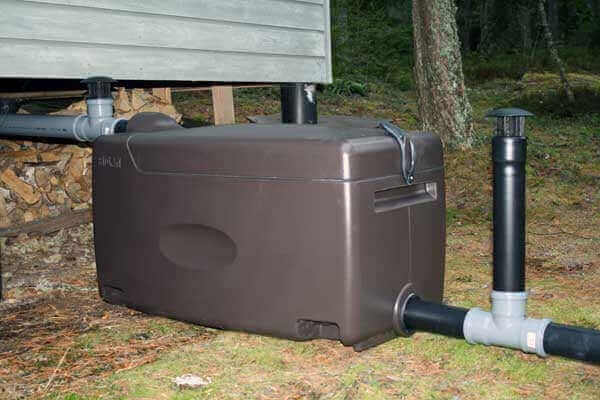 Biolan Light Greywater Filter System installed outdoors at cabin, offered by Cabin Depot, eco-friendly grey water solution.