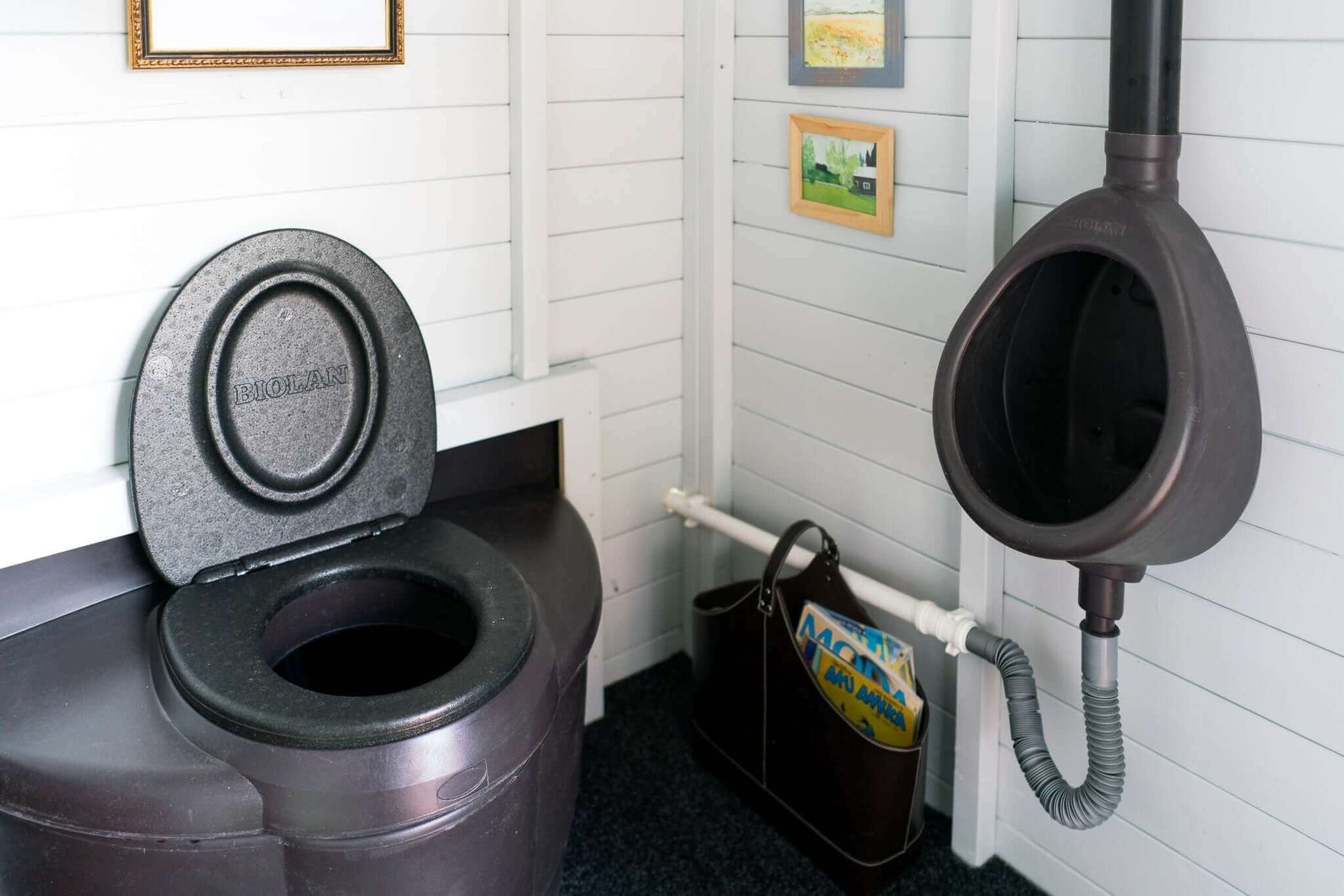 Biolan Populett Composting Toilet at Cabin Depot, perfect for campgrounds and parks, shown in an outhouse setting, eco-friendly solution.