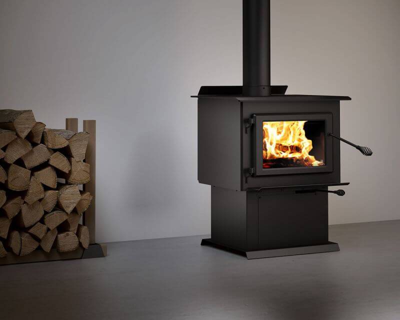 Century FW2900 Wood Stove with burning fire in modern home, Cabin Depot exclusive, featuring durable stainless steel and cast iron design.