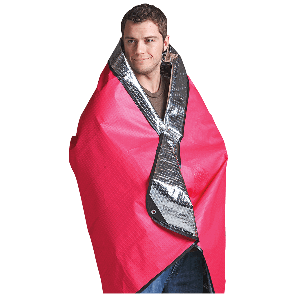 Coghlans Thermal Blanket in use, water and windproof, doubled as tarp, available at Cabin Depot. Size: 50” x 79”, Weight: 12 oz.