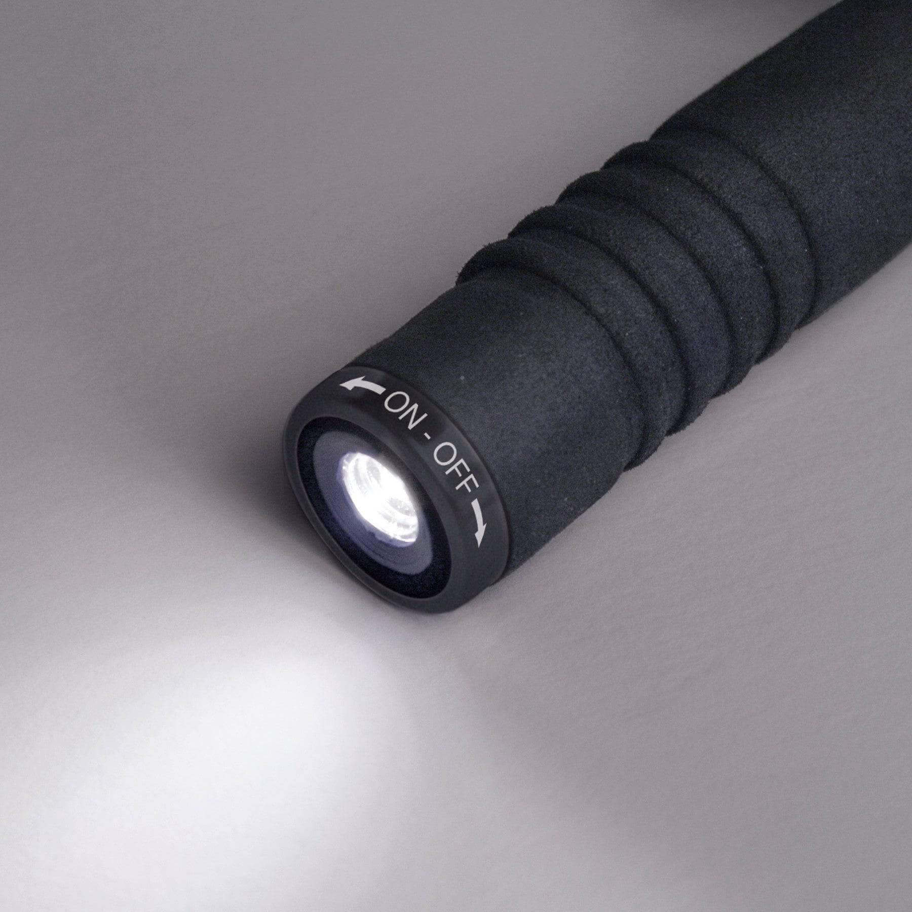 Coghlan's Trekking Umbrella handle with LED light, available at Cabin Depot, showing flashlight function with on/off switch