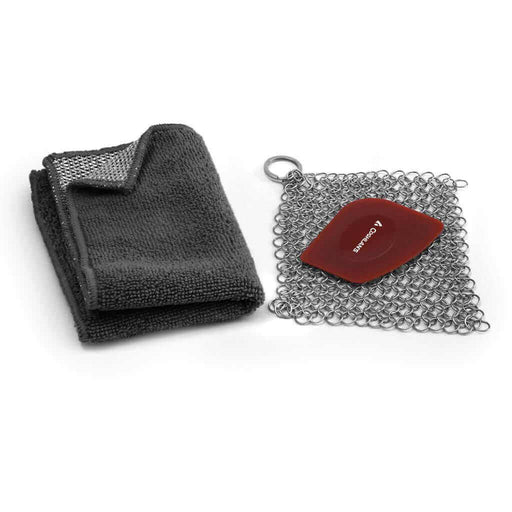 Coghlan's Cast Iron Cleaning Kit with chainmail scrub pad, polycarbonate scraper, and scrubbing washcloth for cookware care.