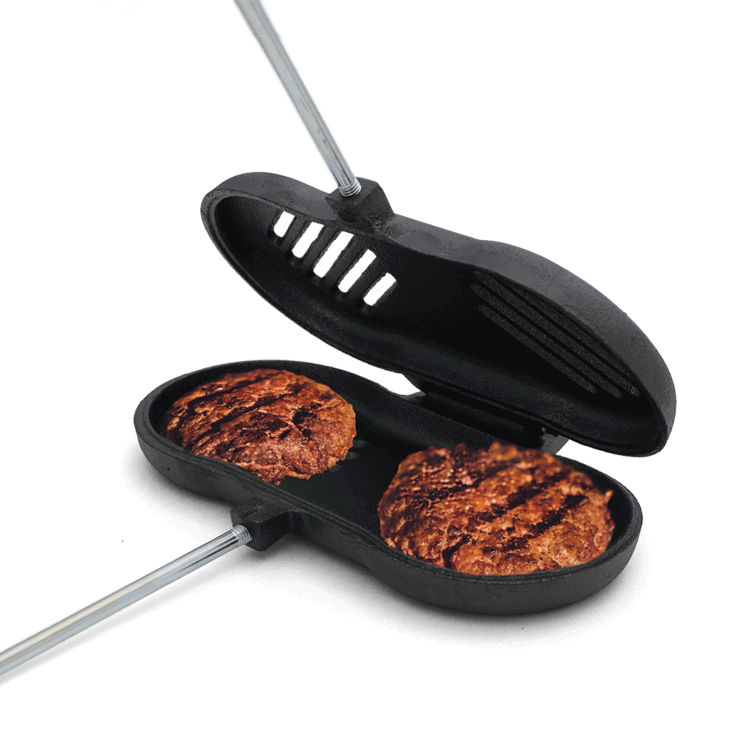 Coghlans Double Cast Iron Broiler with burgers, ideal for campfire cooking, available at Cabin Depot.