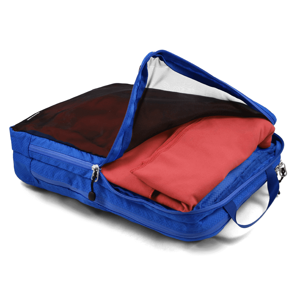 Coghlans Wet Dry Bag in blue with mesh front and zipper, shown with clothes inside, available at Cabin Depot for organized travel use.