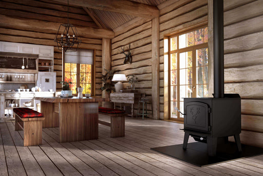 Black Stag II Wood Stove in rustic cabin setting, ideal for eco-friendly heating up to 2,300 sq ft with 90,000 BTU/h output.