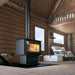 Modern cabin with Drolet Escape 1500 wood stove, ideal for efficient home heating, showing cozy interior with wood panels.