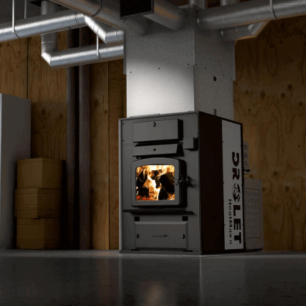 Drolet Heatmax II Wood Furnace in a room, showcasing its design and wood-burning capabilities for efficient heating.