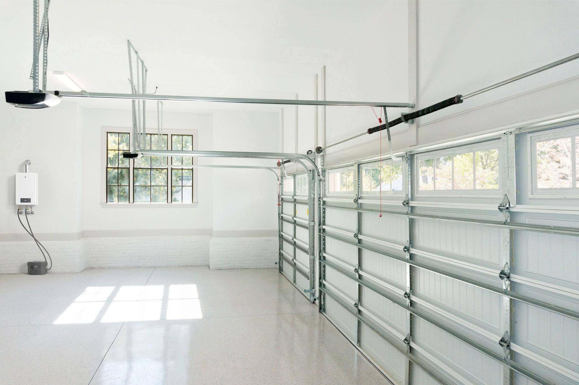 Spacious garage interior with a tankless water heater, showcasing bright lighting and modern design at the Cabin Depot.