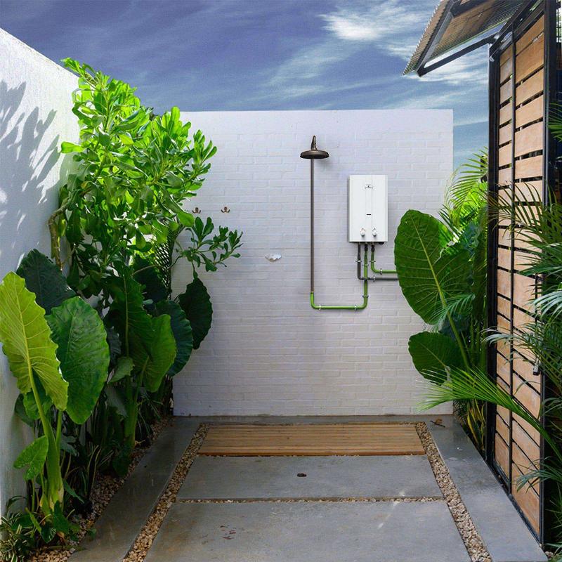 Eccotemp L10 Outdoor Tankless Water Heater installed in a garden shower area, ideal for cabin and summer home use. Cabin Depot exclusive.