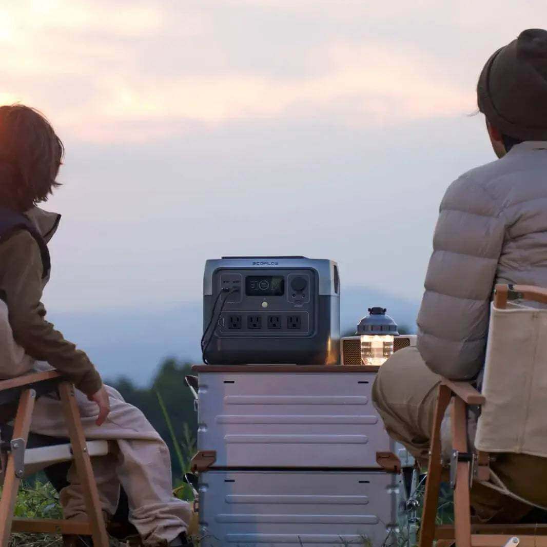 Camping with EcoFlow RIVER 2 Pro Portable Power Station from Cabin Depot at sunset, showcasing its modular design and fast-charging feature.