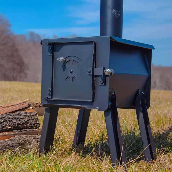 Englander Cub Kit Wood Stove in outdoor setting, featuring heavy-duty steel construction and portable design for versatile use.