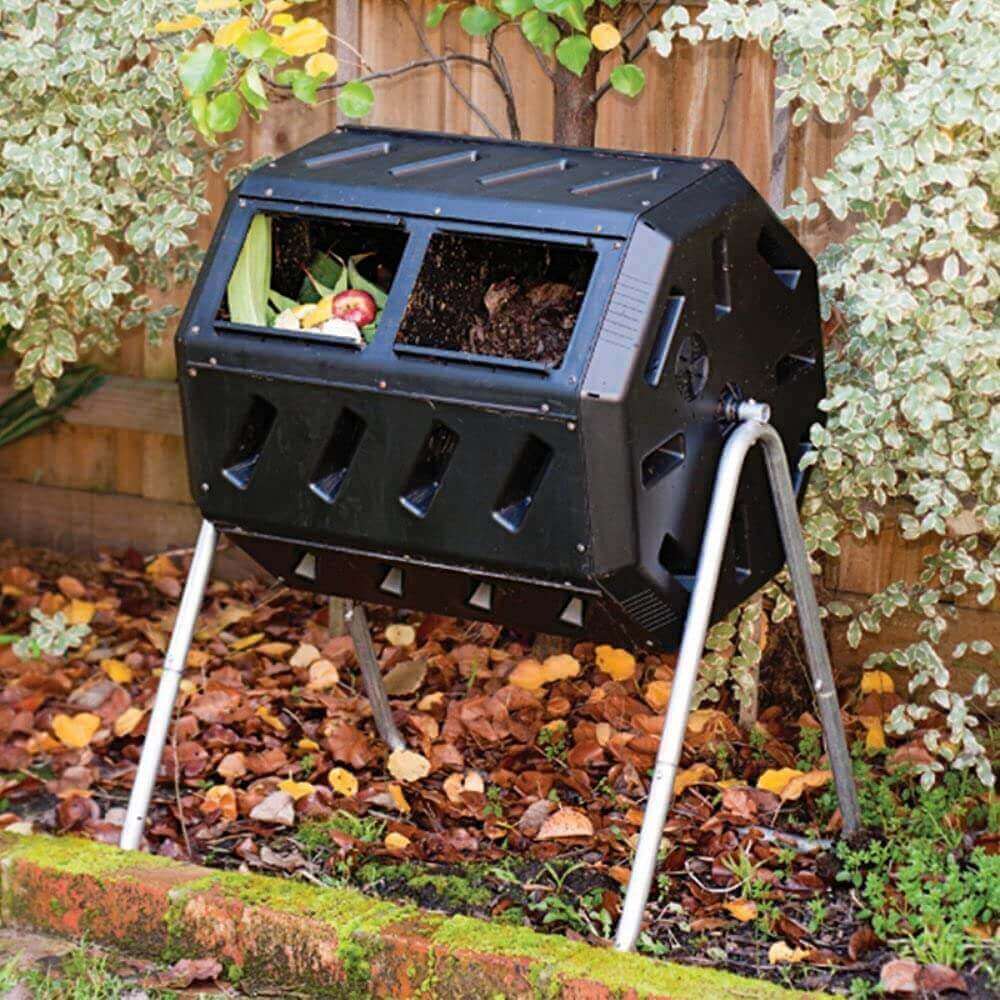 FCMP Outdoor Dual Chamber Tumbling Composter by Cabin Depot in garden setting for quick compost turnaround.