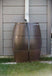 FCMP Outdoor 50Gal Rain Catcher Barrel installed, showcasing traditional barrel design for efficient rainwater collection.