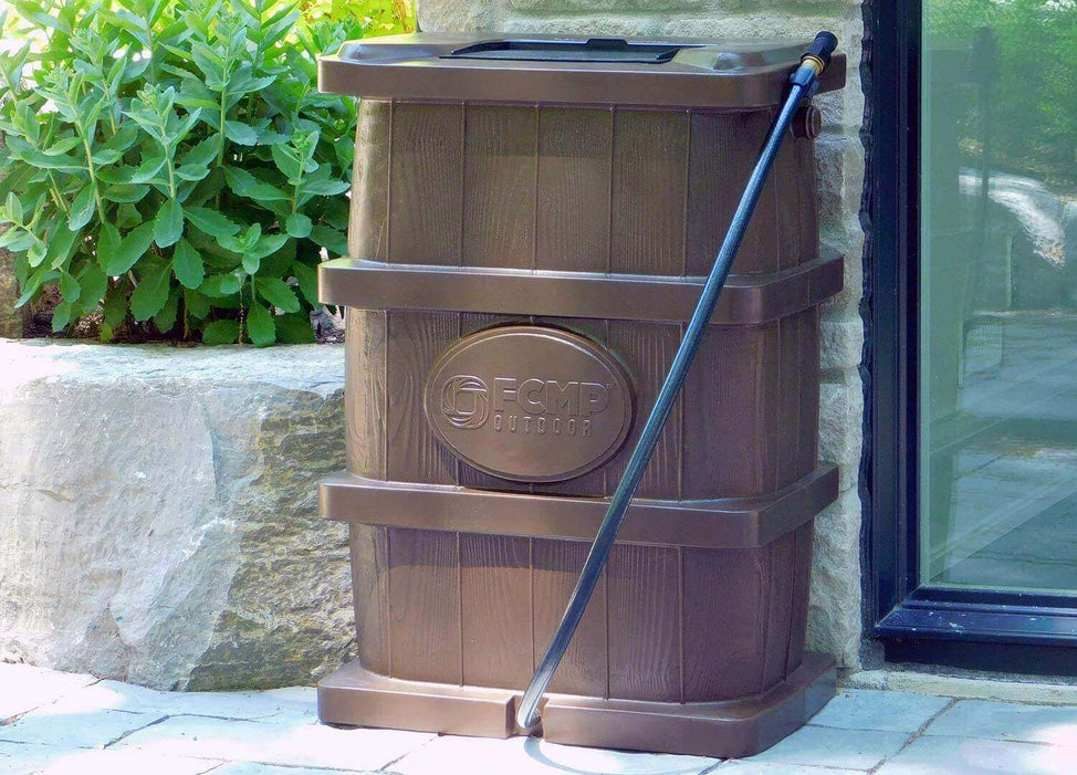 FCMP Outdoor 45Gal Wood Grain Rain Barrel in brown by a garden wall for efficient rainwater collection.