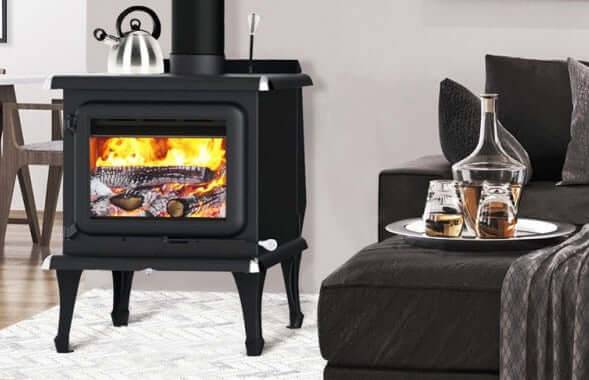 Modern J. A. Roby Sirius wood stove in stylish living room, featuring a cozy fire and elegant decor.