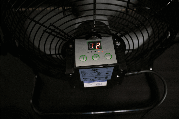 "Close-up of Kedron 12-inch solar powered fan control panel showing speed settings"