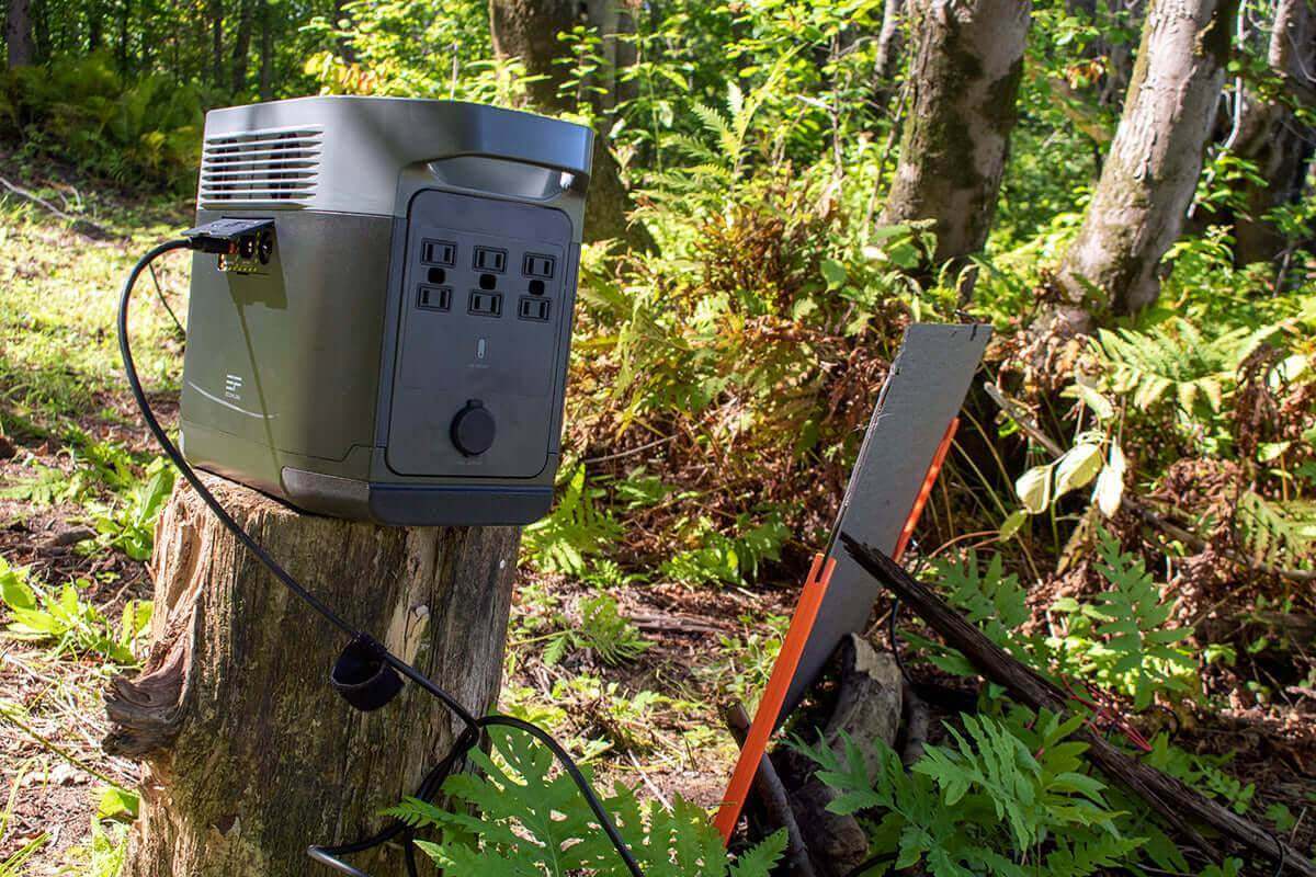 Alt Tag: Kedron 100W solar panel kit charging solar generator outdoors, perfect for cabin use. Available at Cabin Depot.