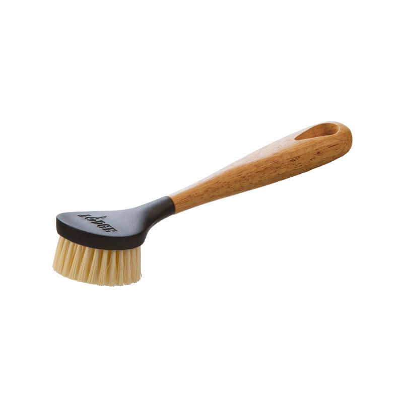 Lodge 10 inch scrub brush with wood handle and nylon bristles, perfect for cast iron cleaning. Available at Cabin Depot.