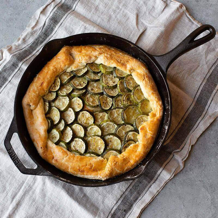 Lodge 12" Chef Skillet with a zucchini galette, showcasing ergonomic design, superior heat retention, and easy-release finish.