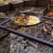 Lodge 12 inch seasoned skillet cooking eggs and vegetables over open fire at Cabin Depot.