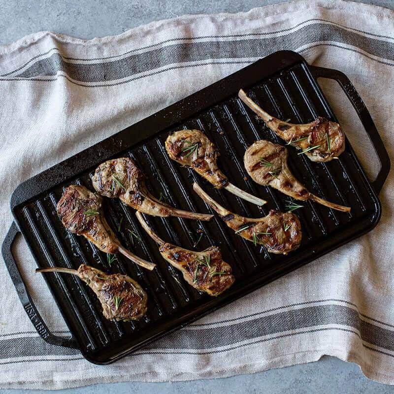 Lodge 19.5x10 Reversible Cast Iron Grill with Lamb Chops - Cabin Depot's Perfect Kitchen Tool for Heat Retention and Easy Cooking