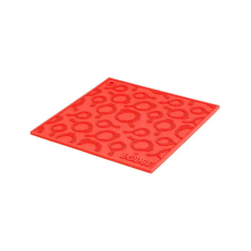 Lodge 7-inch red silicone square trivet with skillet pattern, heat-resistant, available at Cabin Depot for kitchen safety.