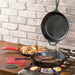 Lodge Essential Pan Set 6 Piece cooking steaks and potatoes on a stovetop, showcasing seasoned cast iron durability and performance.