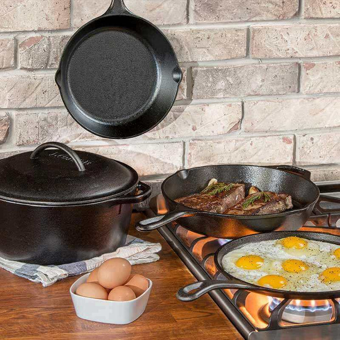 Lodge Pro-Logic Cookware Set 5 Piece in kitchen with frying eggs and steak, showcasing cast iron cooking versatility.