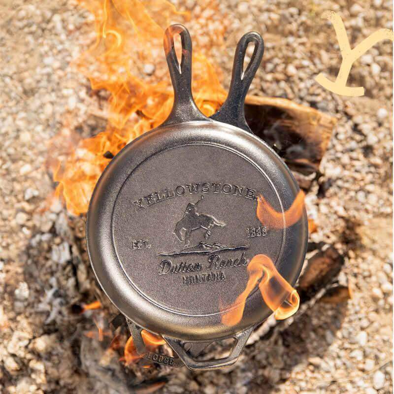 Yellowstone Cast Iron Combo Cooker with Bucking Bronco Design over Campfire - Cabin Depot Edition